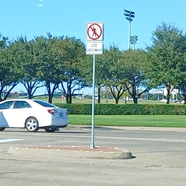 NO PEDESTRIANS. USE CROSSWALK.